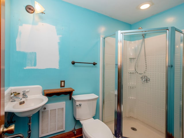 bathroom featuring toilet, hardwood / wood-style floors, walk in shower, and sink