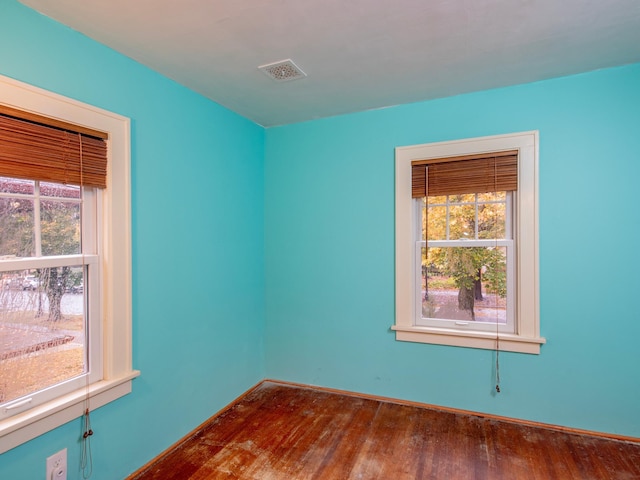 spare room with dark hardwood / wood-style floors