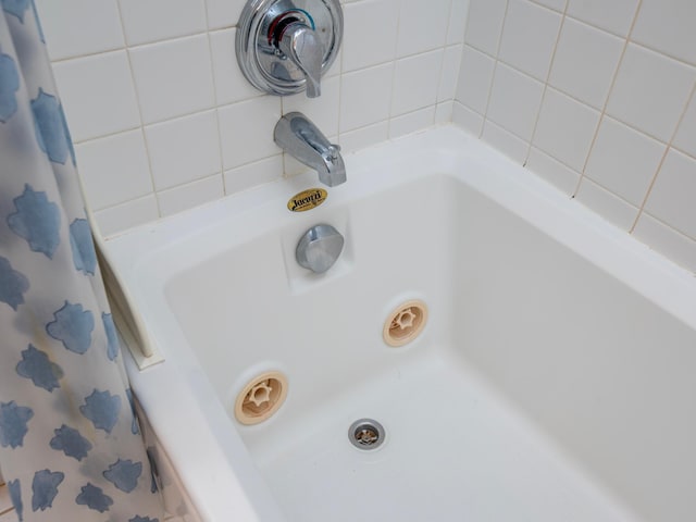 bathroom featuring separate shower and tub