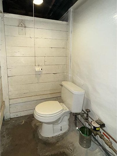 bathroom featuring toilet and concrete flooring