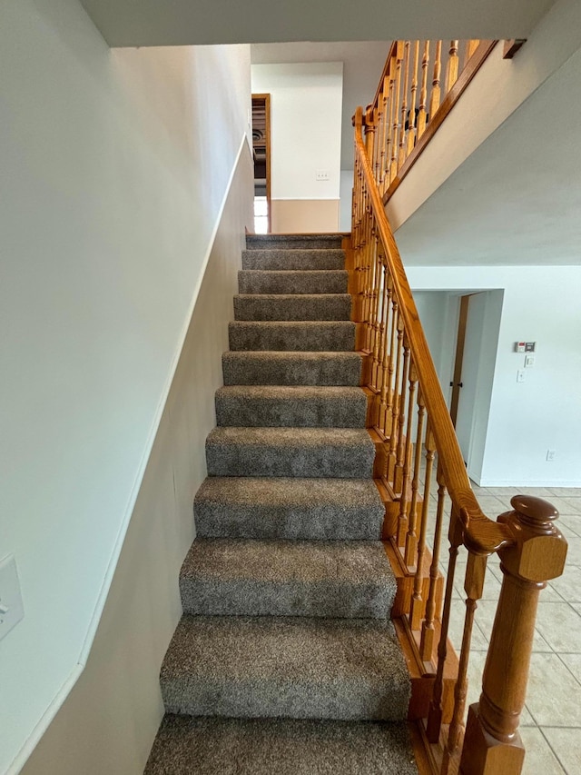 stairs featuring tile patterned floors