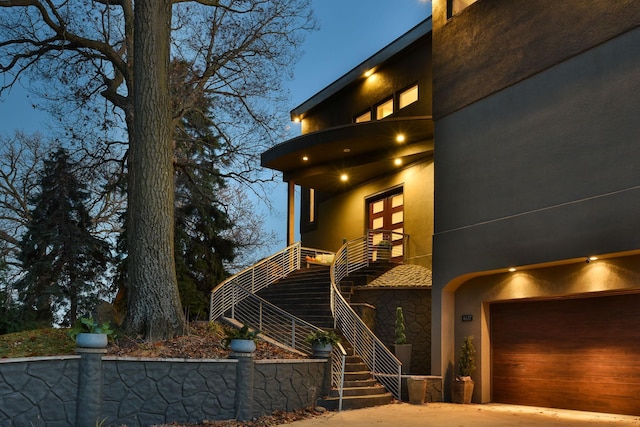 4637 Carlow Rd, Mound, MN 55364 - view of front facade featuring stucco siding, stone siding, stairs, a balcony, and a garage