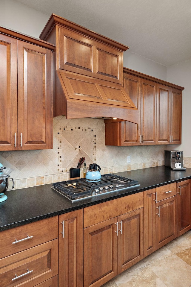 4637 Carlow Rd, Mound, MN 55364 - kitchen featuring stainless steel gas cooktop, brown cabinets, and backsplash
