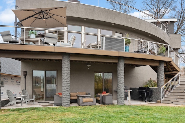 4637 Carlow Rd, Mound, MN 55364 - back of house with stucco siding, a balcony, a patio, and a yard