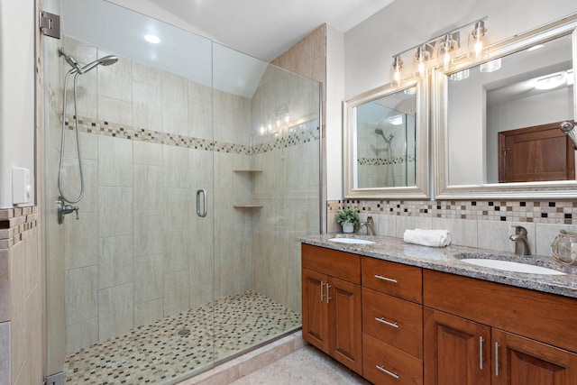 4637 Carlow Rd, Mound, MN 55364 - bathroom with a shower stall, double vanity, and decorative backsplash