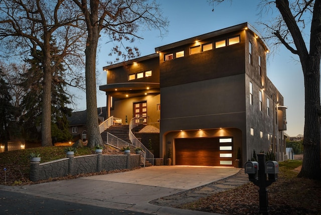 4637 Carlow Rd, Mound, MN 55364 - contemporary home featuring stairway, driveway, a garage, french doors, and stucco siding