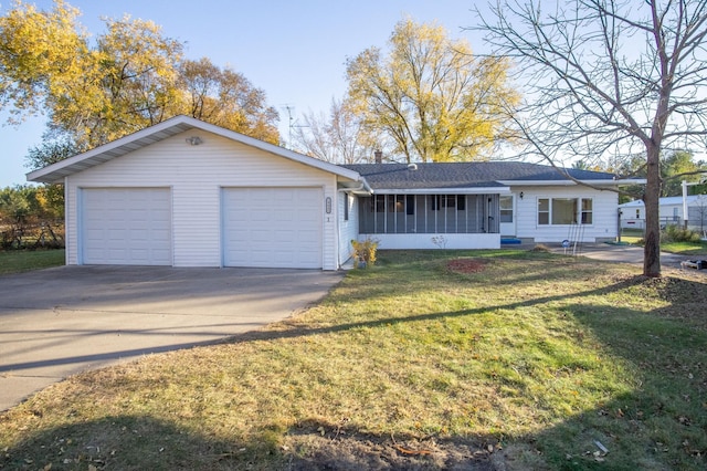 ranch-style house featuring a front yard, a garage, and a sunroom