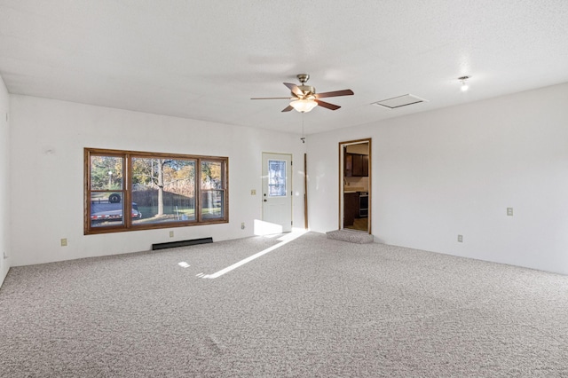 carpeted empty room with a textured ceiling and ceiling fan