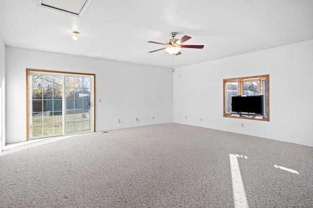 carpeted spare room with a textured ceiling and ceiling fan