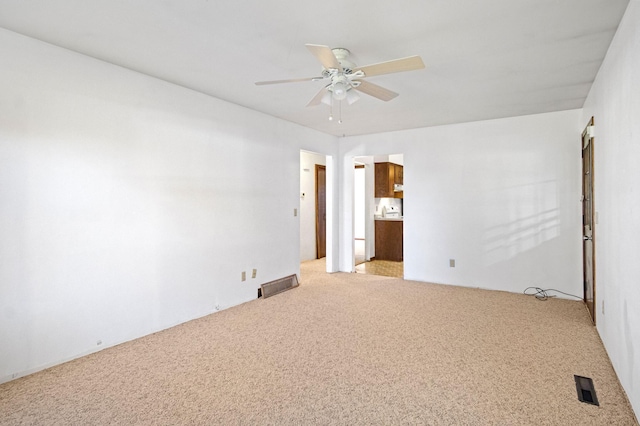 spare room with carpet and ceiling fan