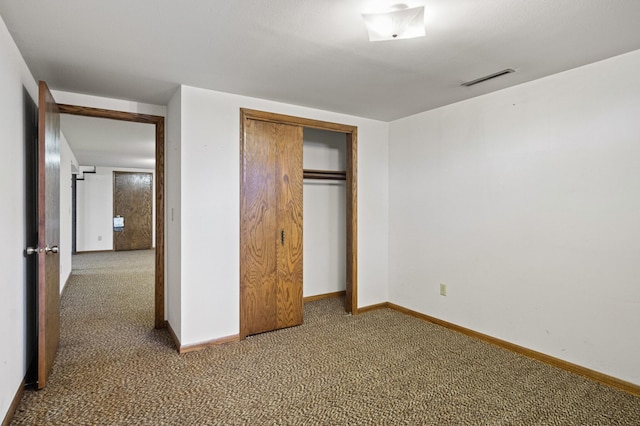 unfurnished bedroom featuring carpet floors and a closet