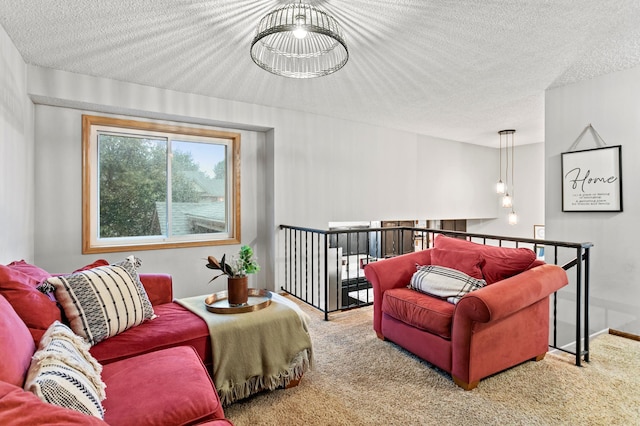 carpeted living room with a notable chandelier and a textured ceiling