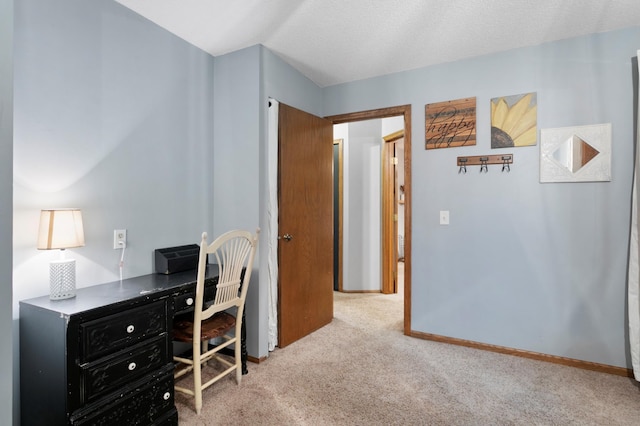 carpeted office space featuring a textured ceiling