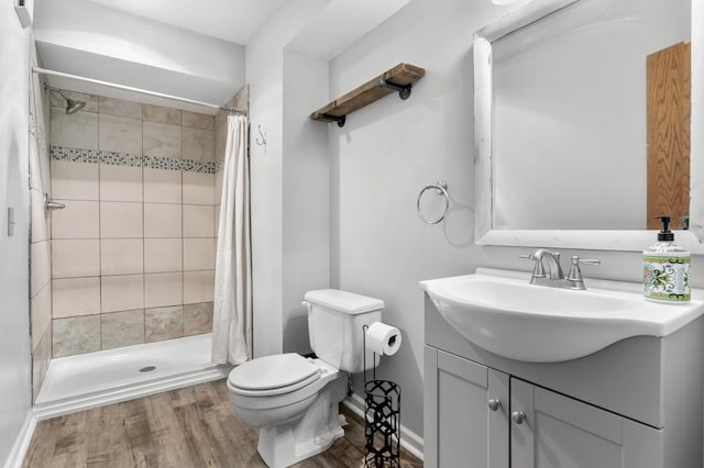 bathroom featuring a shower with shower curtain, vanity, toilet, and hardwood / wood-style floors