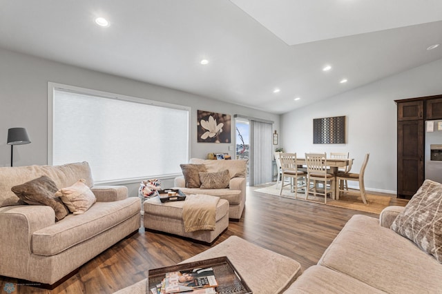 living room with hardwood / wood-style floors and vaulted ceiling