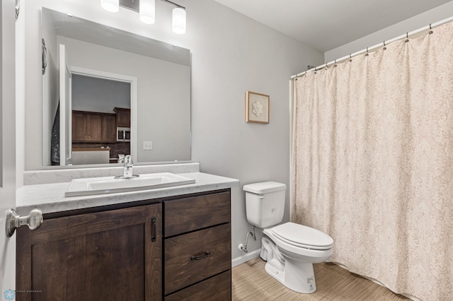 bathroom featuring toilet, vanity, and tile patterned floors