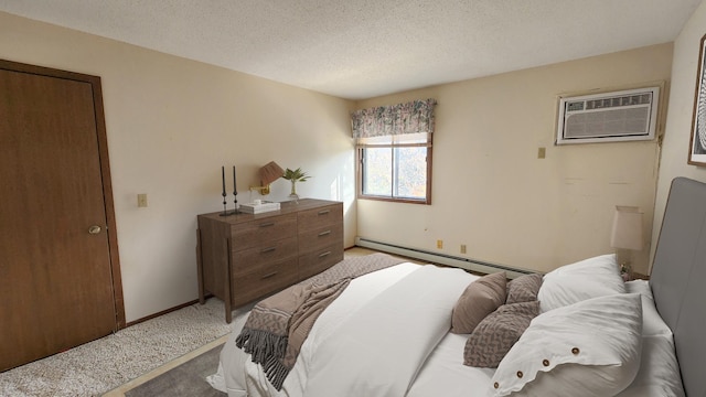 bedroom with baseboard heating, light colored carpet, a textured ceiling, and a wall unit AC