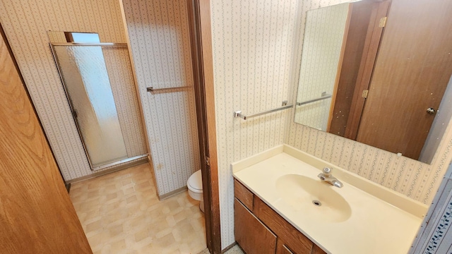 full bath with a shower stall, wallpapered walls, vanity, baseboards, and toilet