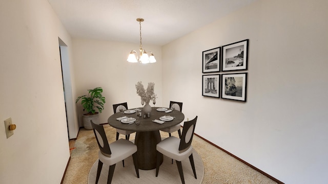dining area featuring light carpet, a chandelier, and baseboards