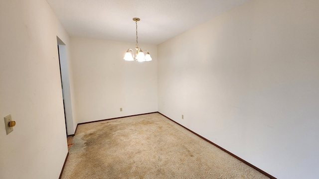 unfurnished room with light carpet, baseboards, and a notable chandelier