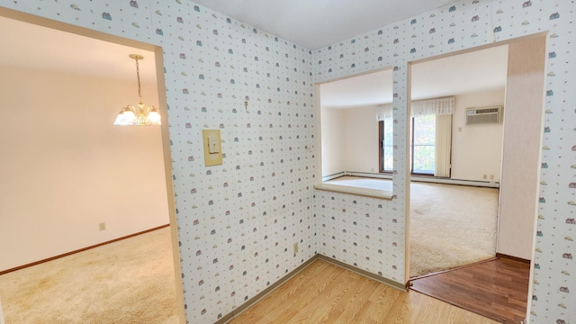 11160 Anderson Lakes Pkwy Unit 313, Eden Prairie, MN 55344 - carpeted spare room featuring wallpapered walls, wood finished floors, a wall mounted air conditioner, and a chandelier