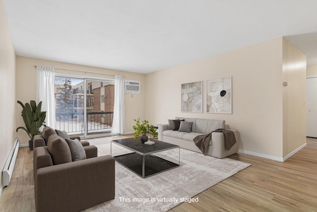 living area featuring baseboard heating, a wall mounted AC, baseboards, and wood finished floors