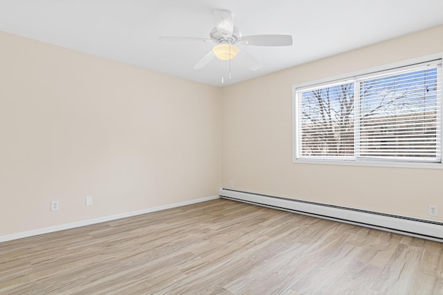 empty room with light wood finished floors, a ceiling fan, a baseboard heating unit, and baseboards