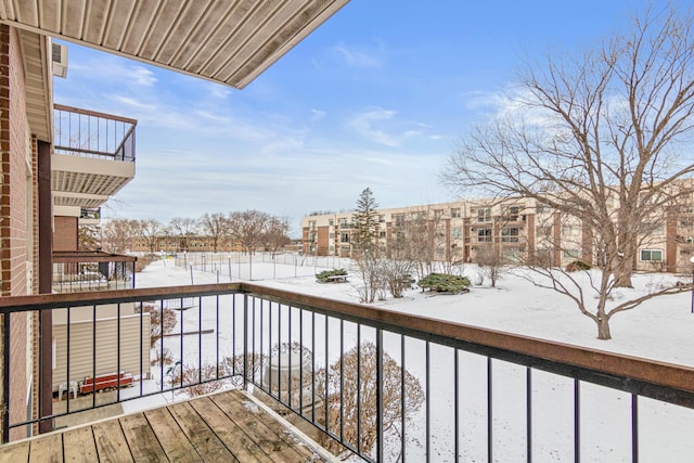 view of snow covered back of property