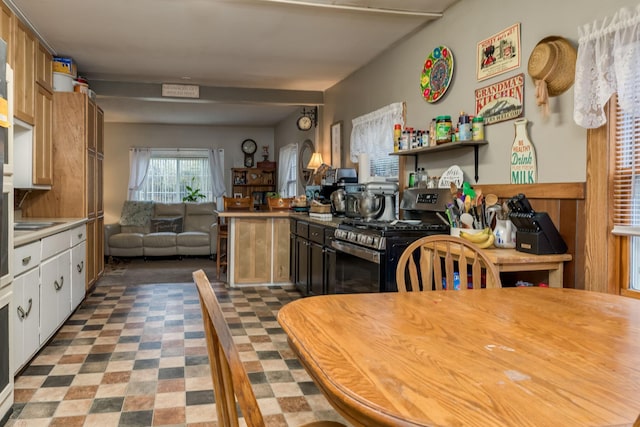 kitchen with white cabinets and stainless steel stove