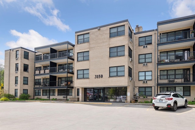 view of building exterior featuring uncovered parking