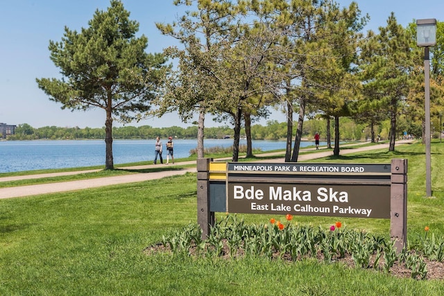 view of property's community with a yard and a water view