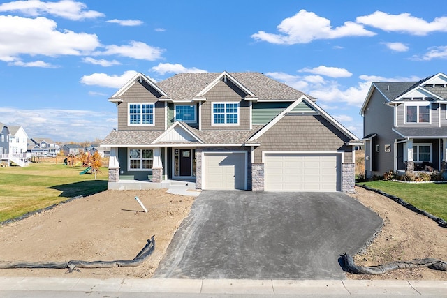 craftsman-style home with a front yard and a garage