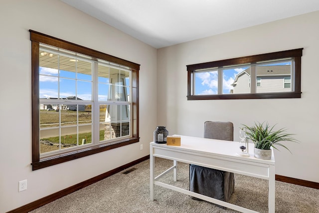 office space with carpet floors and a healthy amount of sunlight