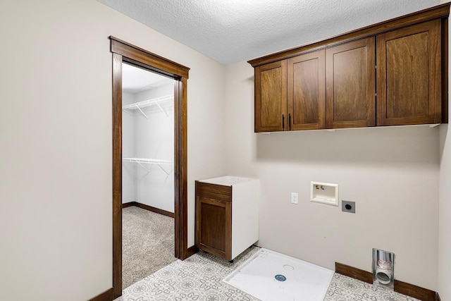 laundry area featuring washer hookup, hookup for an electric dryer, light colored carpet, cabinets, and a textured ceiling