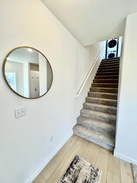 staircase with hardwood / wood-style flooring