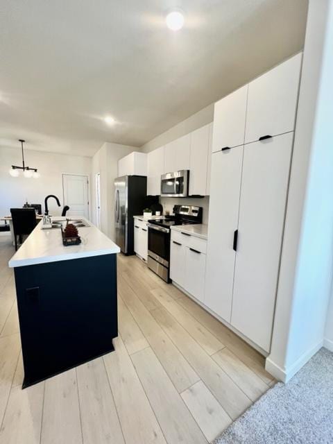 516 Elm St, Redwood Falls, MN 56283 - kitchen featuring stainless steel appliances, a sink, white cabinets, and light countertops