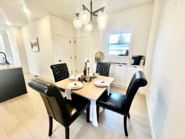 dining area featuring a chandelier and light hardwood / wood-style flooring