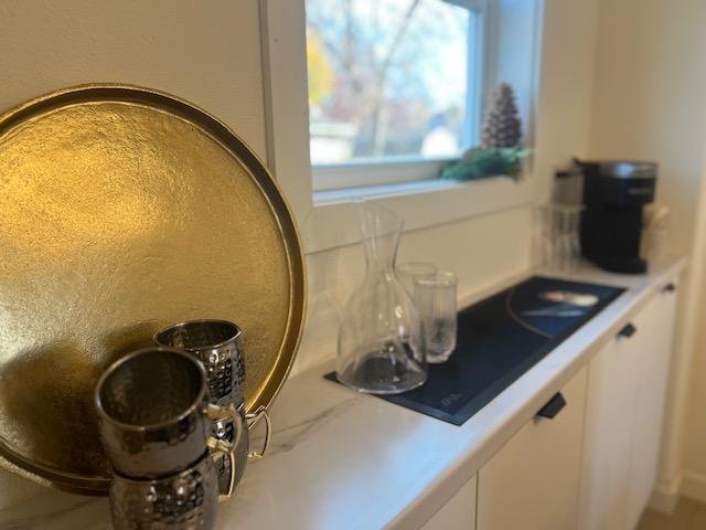 details featuring white cabinetry and black cooktop