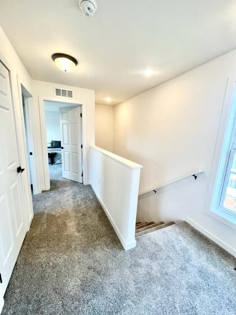 516 Elm St, Redwood Falls, MN 56283 - corridor with an upstairs landing, carpet flooring, and baseboards