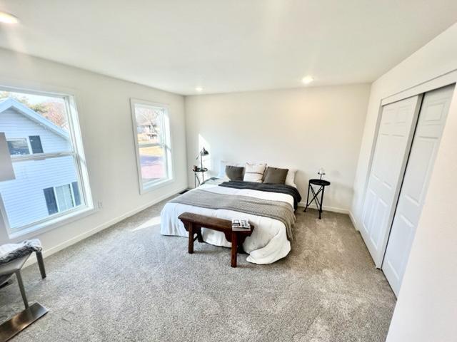 carpeted bedroom with a closet