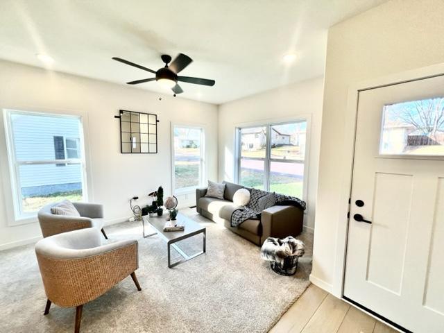 516 Elm St, Redwood Falls, MN 56283 - living area with ceiling fan, light wood-style flooring, and baseboards