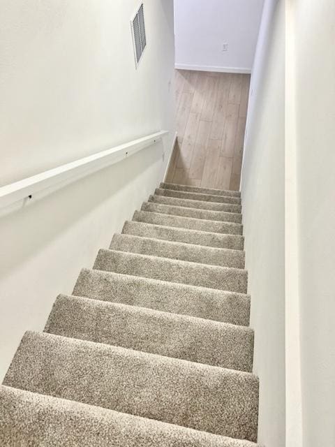 stairway featuring hardwood / wood-style flooring