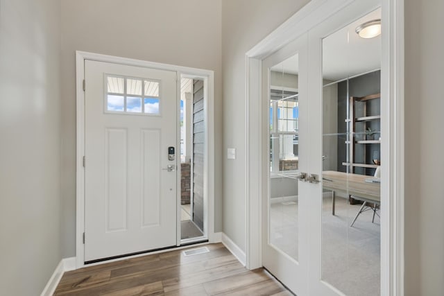 entrance foyer with french doors, light hardwood / wood-style flooring, and plenty of natural light