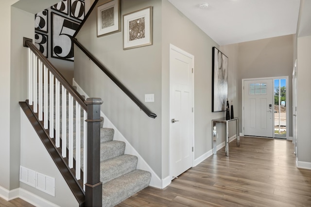 stairway with hardwood / wood-style flooring