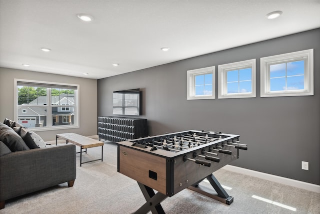 recreation room featuring light carpet