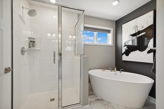 bathroom featuring shower with separate bathtub