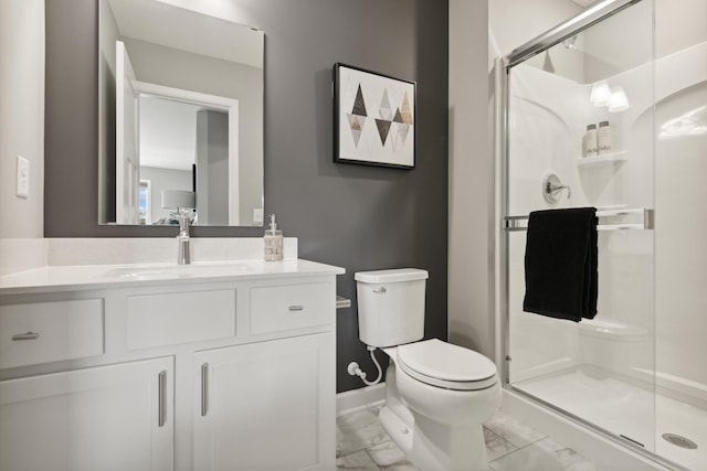 bathroom featuring vanity, an enclosed shower, and toilet