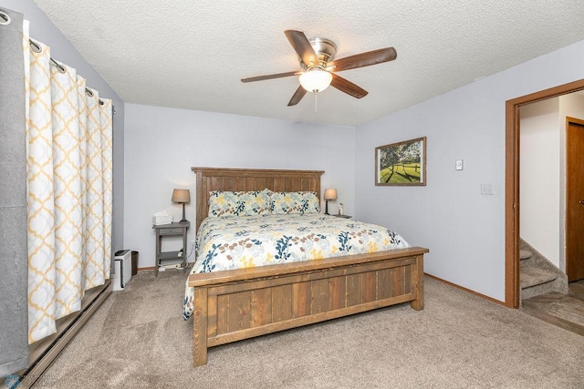 bedroom featuring carpet flooring, ceiling fan, and a textured ceiling