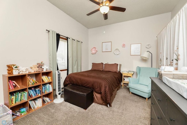 bedroom featuring ceiling fan, light carpet, and a textured ceiling