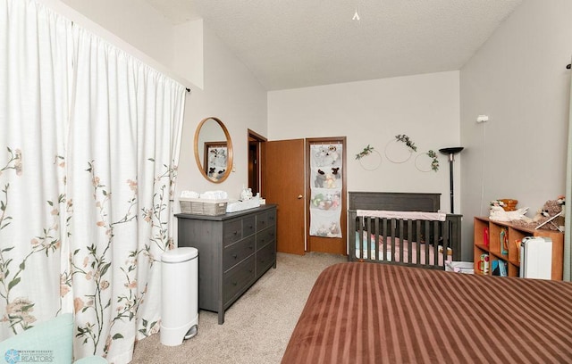 bedroom with light carpet and a nursery area